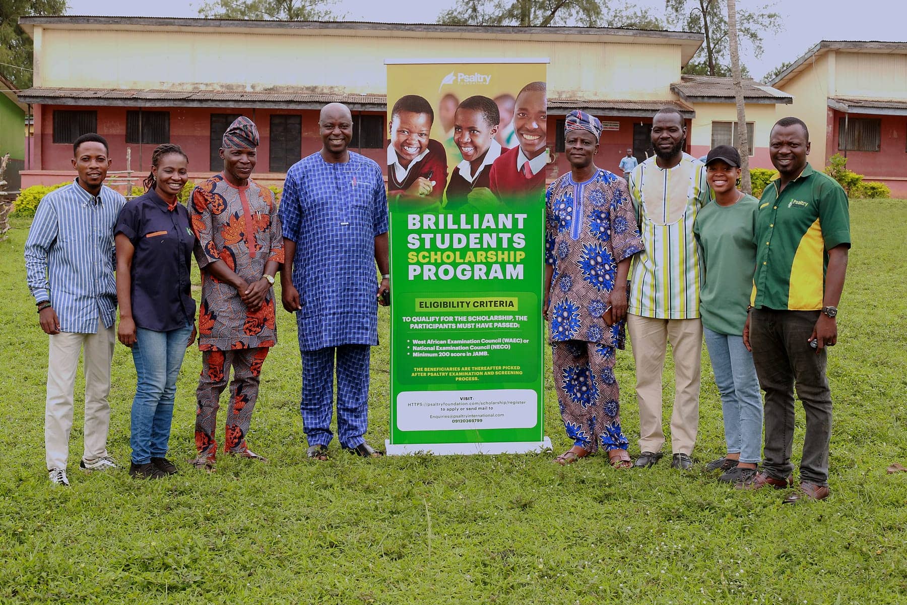 Psaltry Foundation field team with a Brilliant Students' Scholarship banner outside a rural school